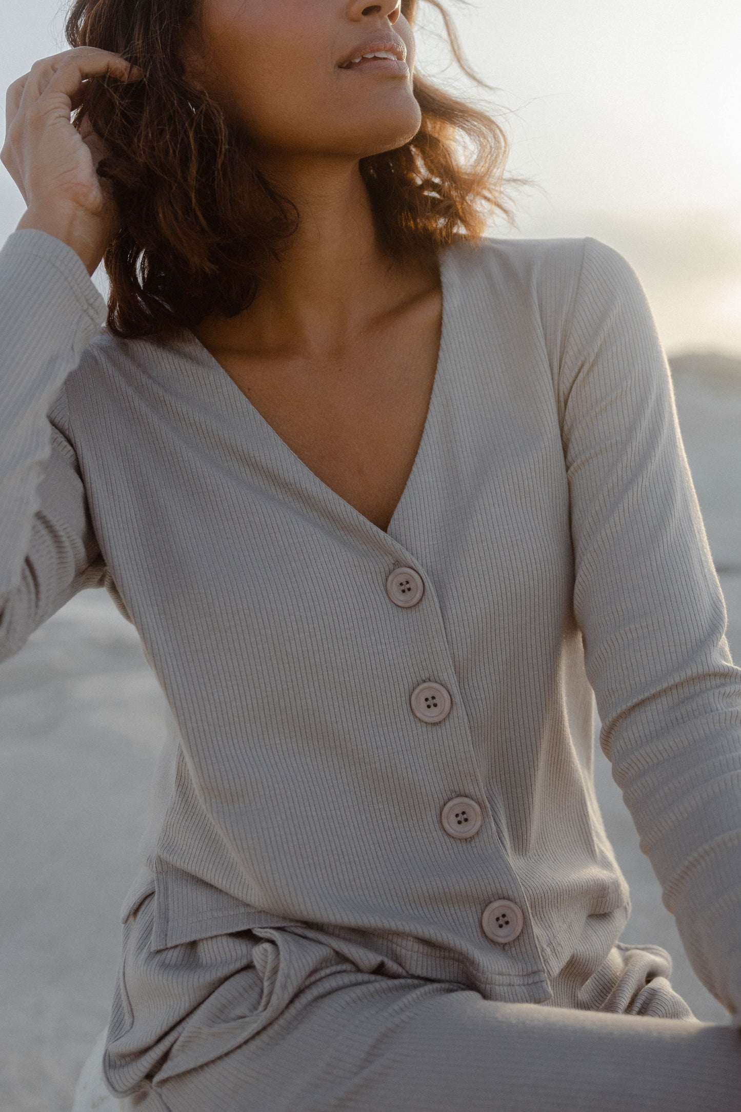 This 'Abby’ top is made from ribbed stretch-knit that sits nicely around your frame and has buttons that can be adjusted to your preferred coverage. It pairs perfectly with the matching pants and also looks great with wide-leg jeans.